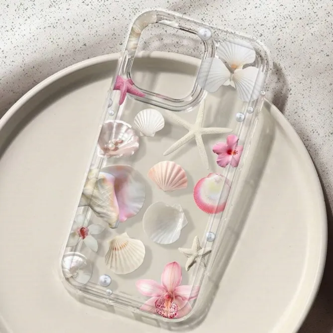 Coque iPhone 16 Plus transparente motif coquillages étoiles de mer et fleurs